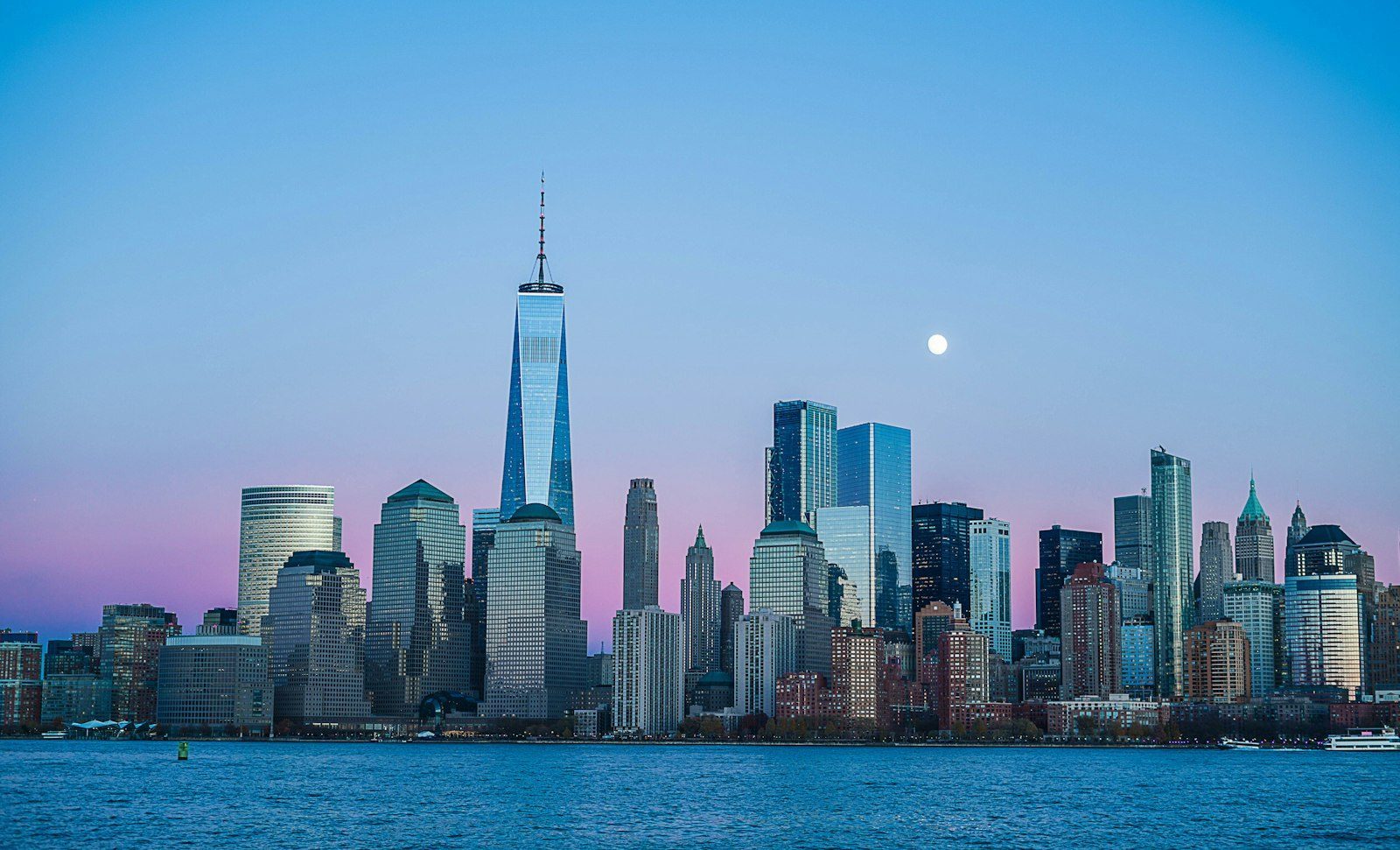 A city skyline across the water at dusk